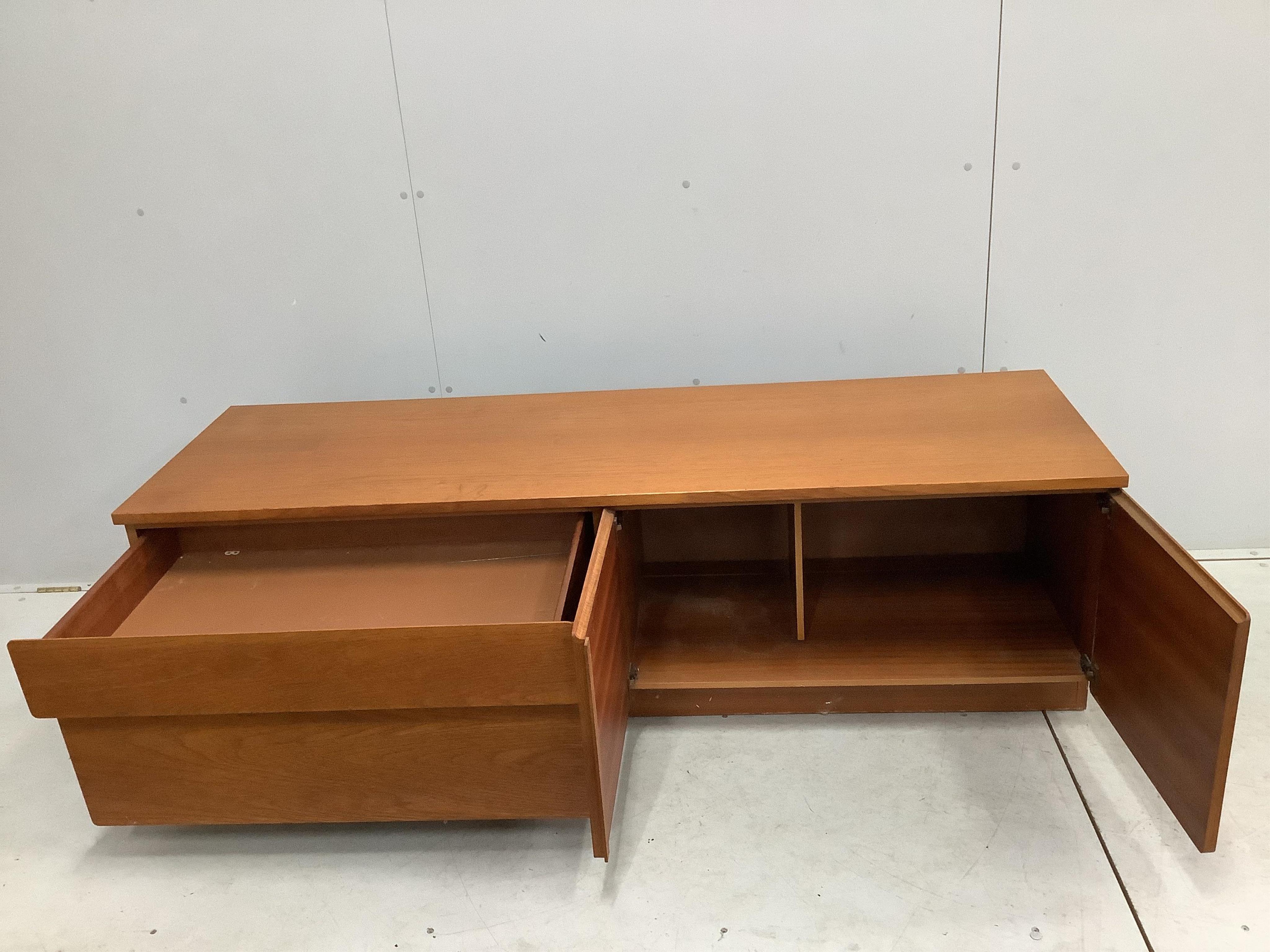 A mid century McIntosh teak extending dining table, width 150cm, depth 82cm, height 74cm together with four chairs, and a low sideboard. Condition - fair to good